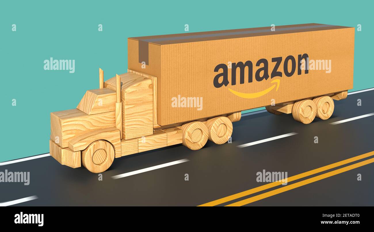 Camion de jouets en bois, transportant une grande boîte en carton avec le  logo Amazon, se déplace rapidement sur la route Photo Stock - Alamy