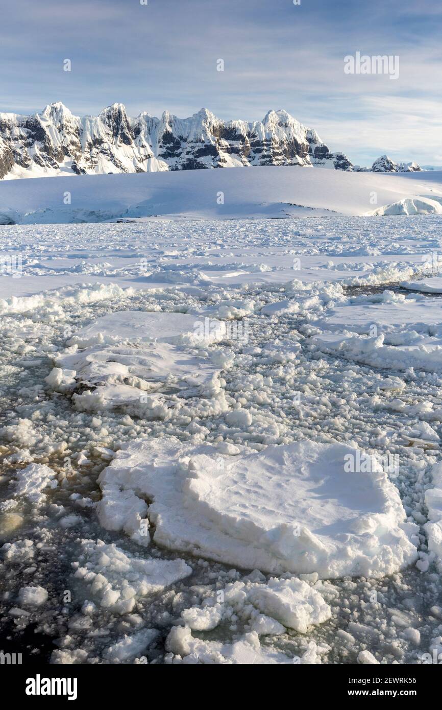 Montagnes enneigées et glace de mer dense dans le chenal Neumayer, l'archipel de Palmer, l'Antarctique, les régions polaires Banque D'Images