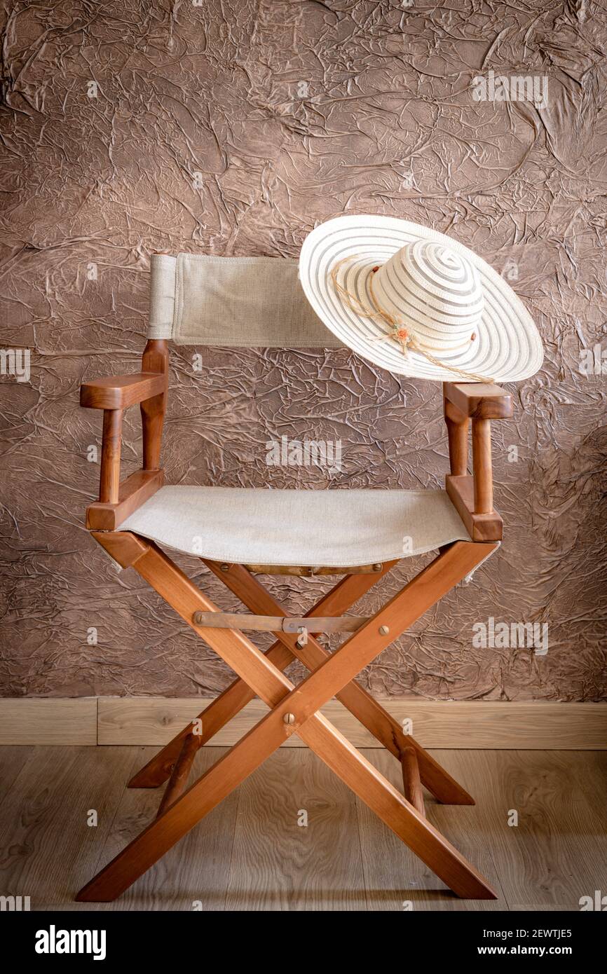 Chaise de directeur avec une bande sur la base, un élégant chapeau pour  femmes, style vintage. Vide endroit Photo Stock - Alamy