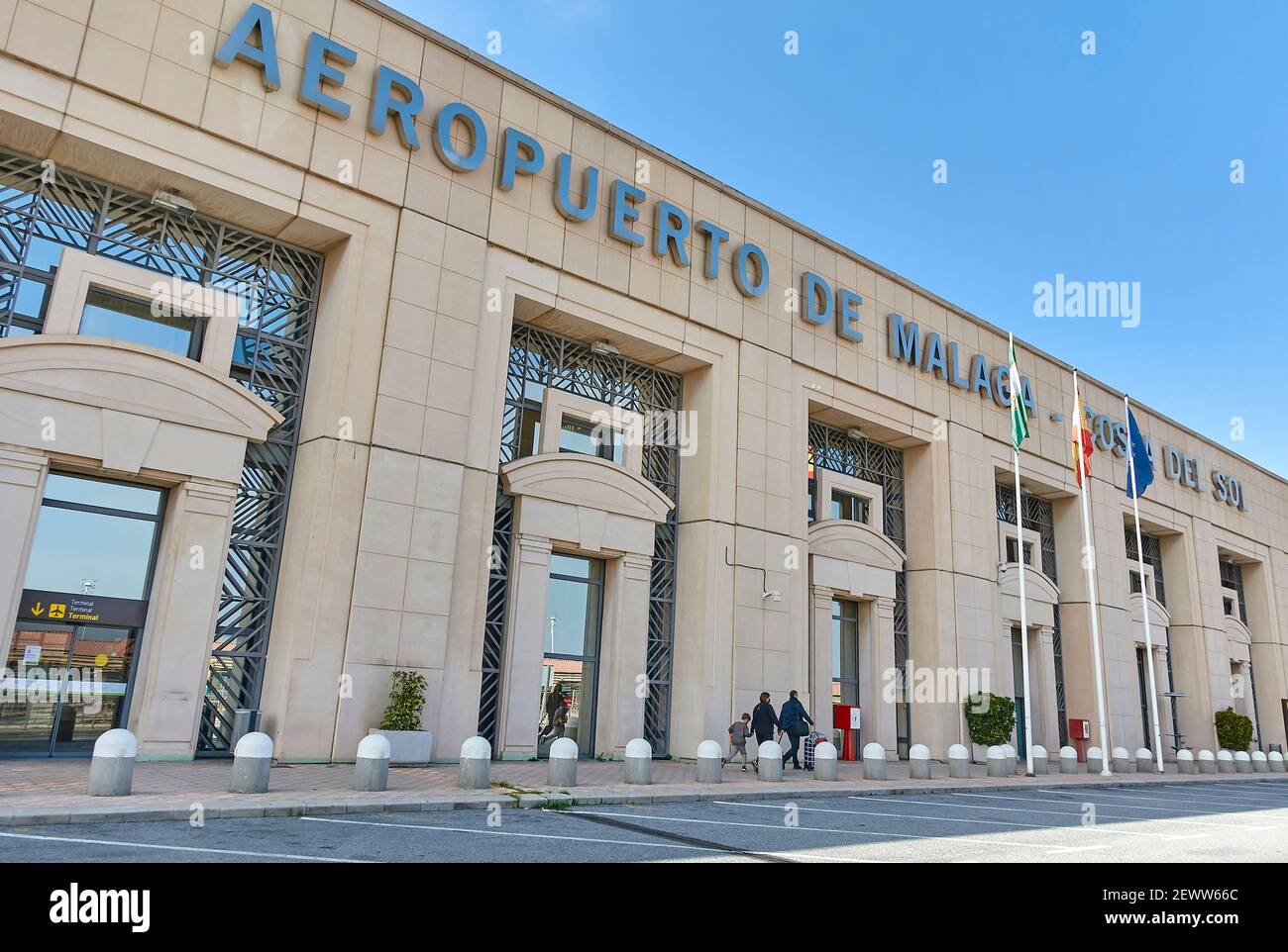 Un groupe de familles se promène devant un terminal de l'aéroport de Malaga sous un ciel bleu, Costa del sol, Espagne Banque D'Images