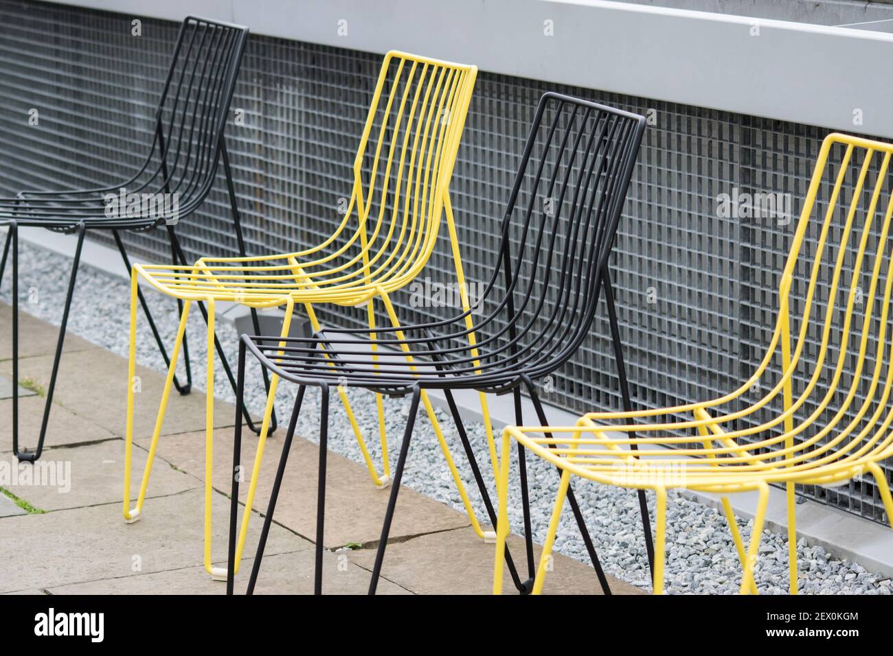 Chaises d'extérieur jaunes et noires sur un patio Banque D'Images