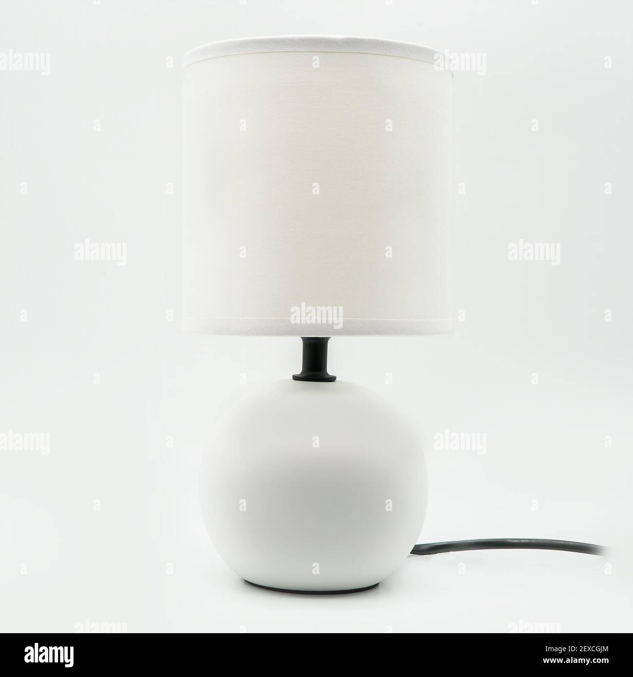 Une lampe de table moderne avec abat-jour blanc et base en céramique, découpée sur fond blanc Banque D'Images