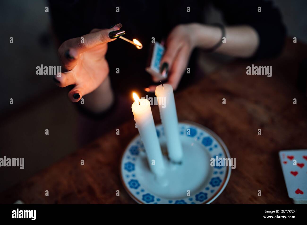un tueur de fortune allume des bougies rituelles pour prédire l'avenir utilisation de cartes Banque D'Images