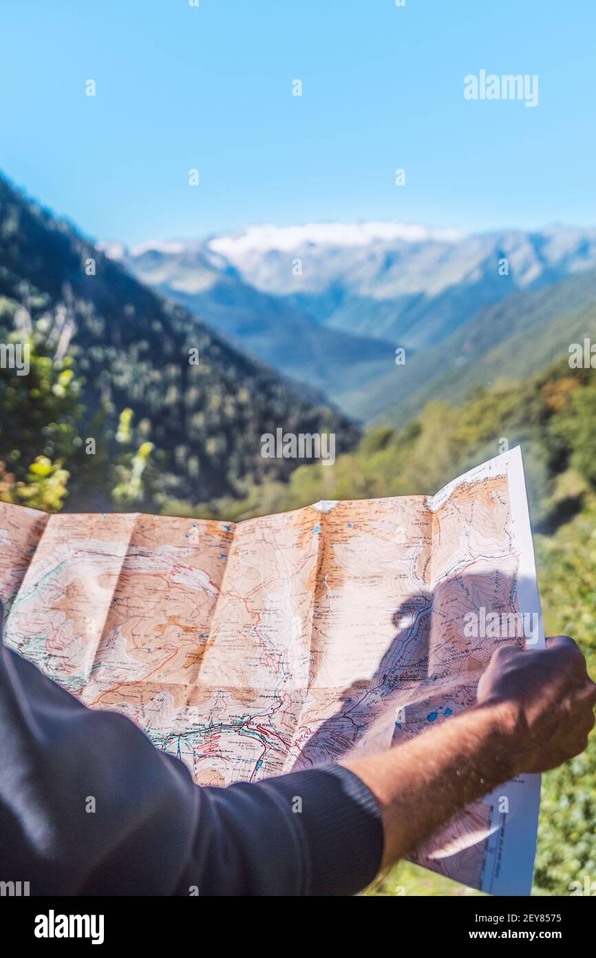Personne anonyme regardant l'itinéraire de voyage sur une carte dans la montagne. Itinéraires, excursions et sentiers de montagne à travers la nature en été. Concept d'explantation Banque D'Images