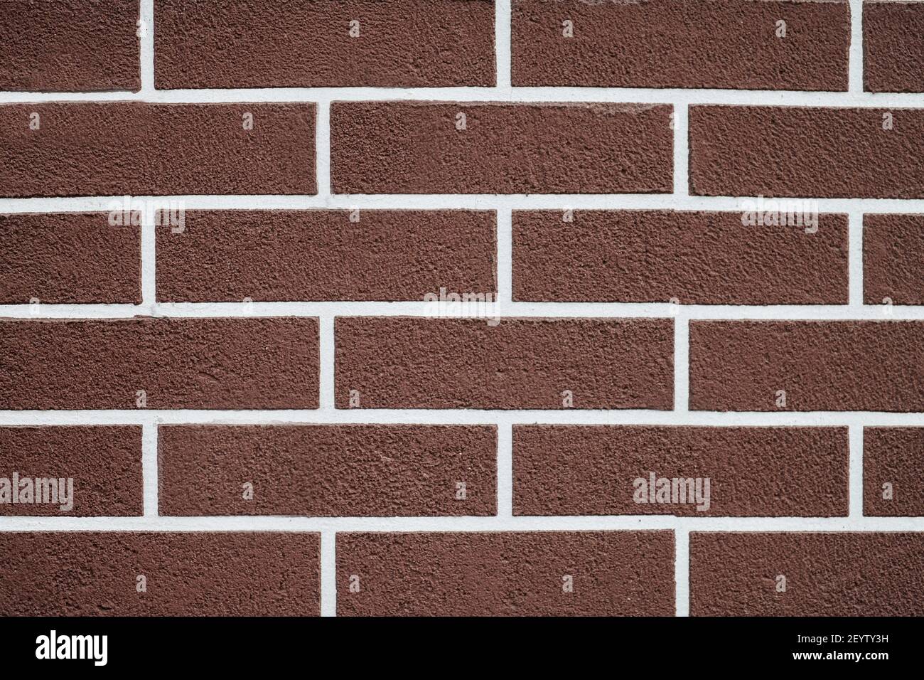 Mur de briques marron avec motif de lignes de coulis blanches. Arrière-plan de texture de brique abstraite. Extérieur de la nouvelle maison. Style loft. Banque D'Images