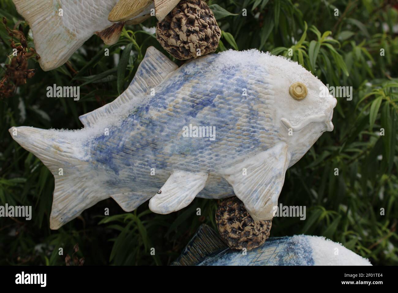 Sculpture d'art de poisson en céramique dans un jardin Banque D'Images