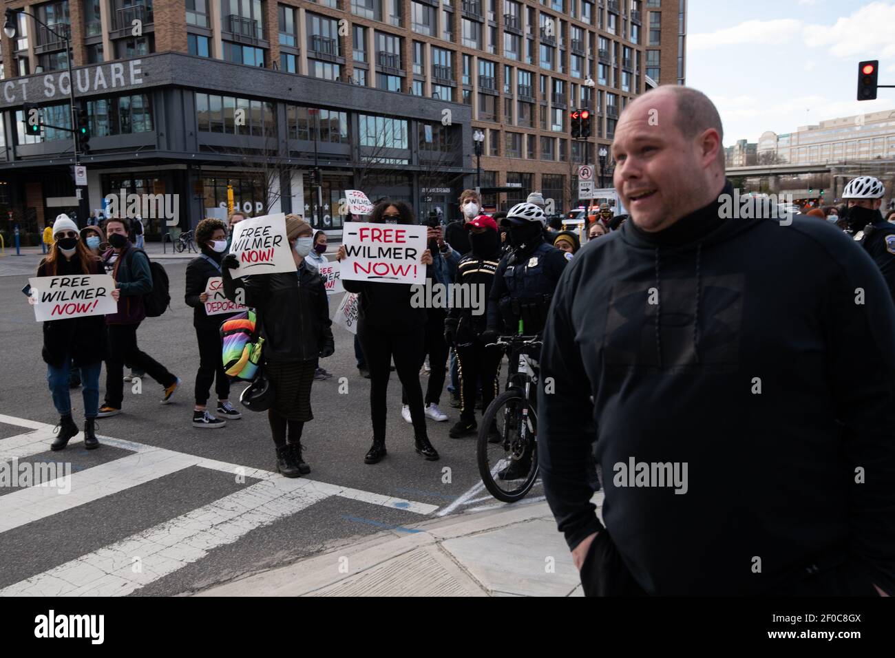 Un piéton qui a confronté les manifestants à Free Wilmer, une campagne pour la libération immédiate d'un migrant hondurien nommé Wilmer qui a été détenu pendant deux ans en vertu de la politique d'asile de l'Administration Trump, part après avoir été averti par la police métropolitaine alors que le groupe a défilé dans le centre-ville de Washington, DC, samedi, 6 mars 2021, au milieu de la pandémie du coronavirus. Wilmer a été initialement détenu en 2019, et les manifestants appellent maintenant l'administration Biden à agir sur son cas et sur d'autres migrants détenus de manière similaire. (Graeme Sloan/Sipa USA) Banque D'Images