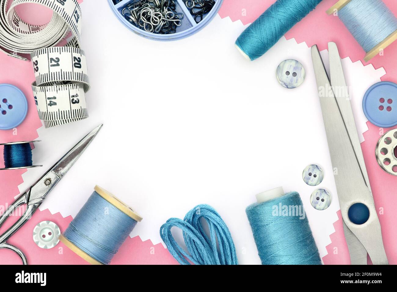 Gabarit rose pour le produit de couture avec fond blanc et jeu d'outils de couture, ciseaux, mètre ruban, bouton et bobine de fils Banque D'Images