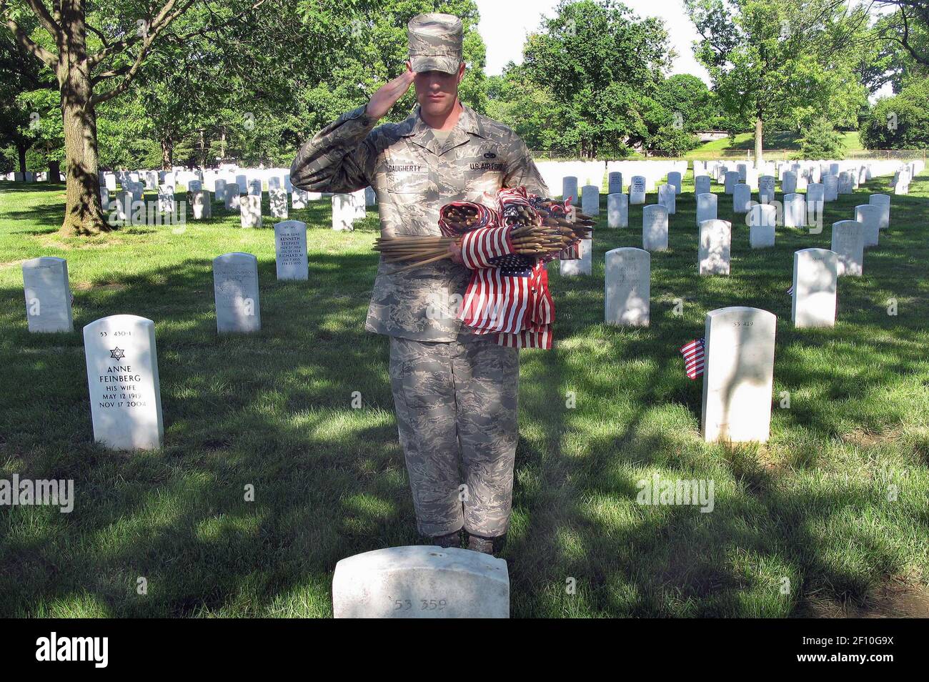 21 mai 2009 - Arlington, D.C. - Jacob Proffer, membre de la Garde d'honneur de l'Armée de l'Air des États-Unis, s'arrête pour saluer une tombe après avoir placé un drapeau miniature à sa base pendant l'hommage rendu aux drapeaux Iní“ au cimetière national d'Arlington, le 21 mai 2009. Quand je fais cela, il me fait prendre beaucoup plus de fierté chaque fois que je mets mon uniforme, voyant la mesure du sacrifice que beaucoup ont fait, il dit. Crédit photo : Donna Miles/DOD/Sipa Press/0905221905 Banque D'Images