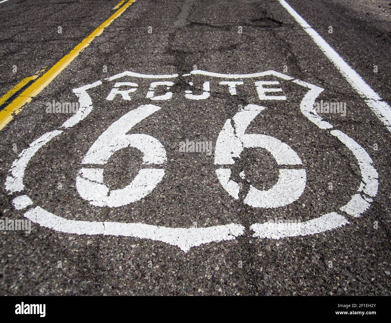 Longue route avec un panneau de la route 66 peint dessus Banque D'Images