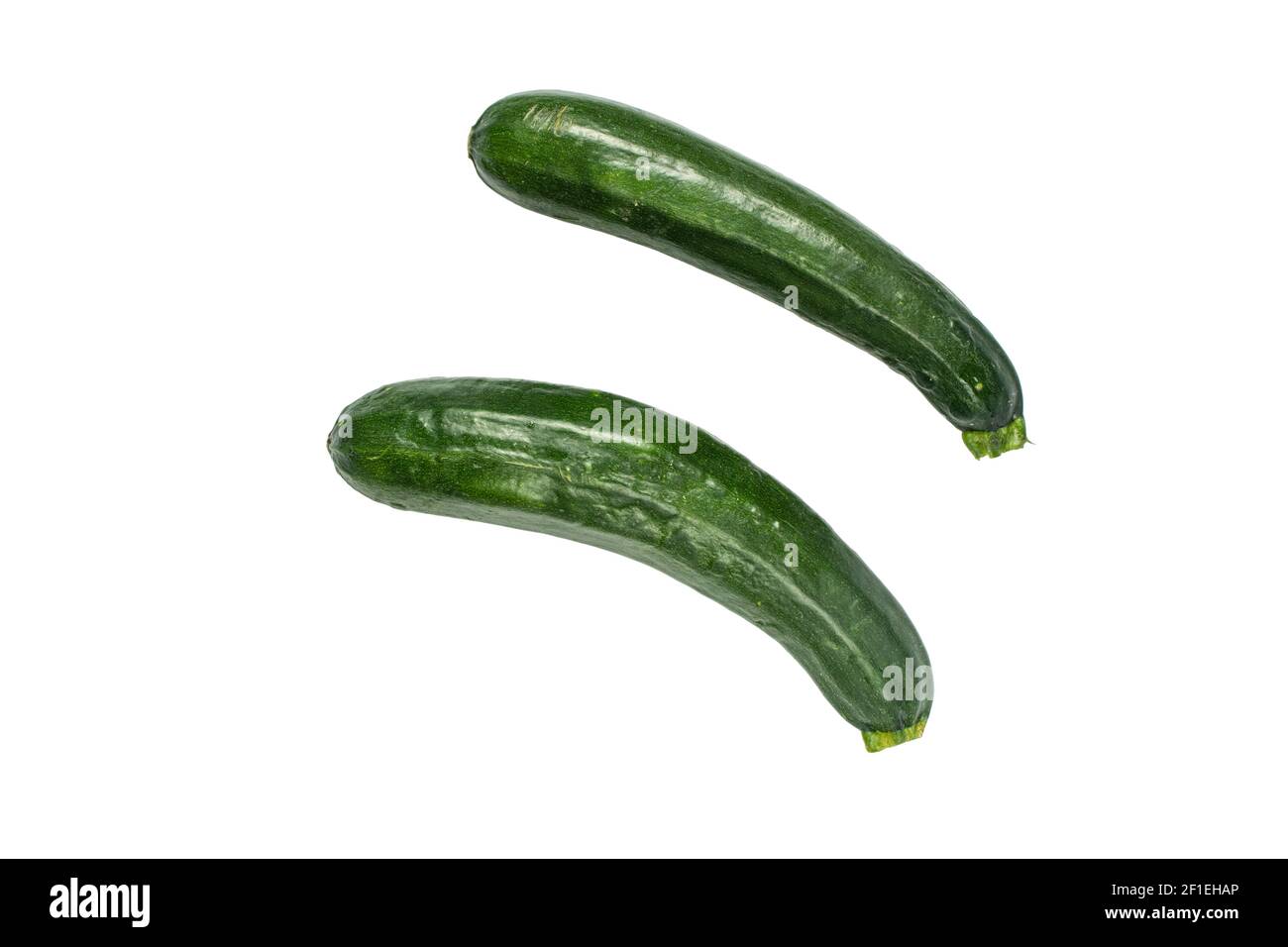 Fruits crus de courgettes vert foncé isolés sur du blanc Banque D'Images