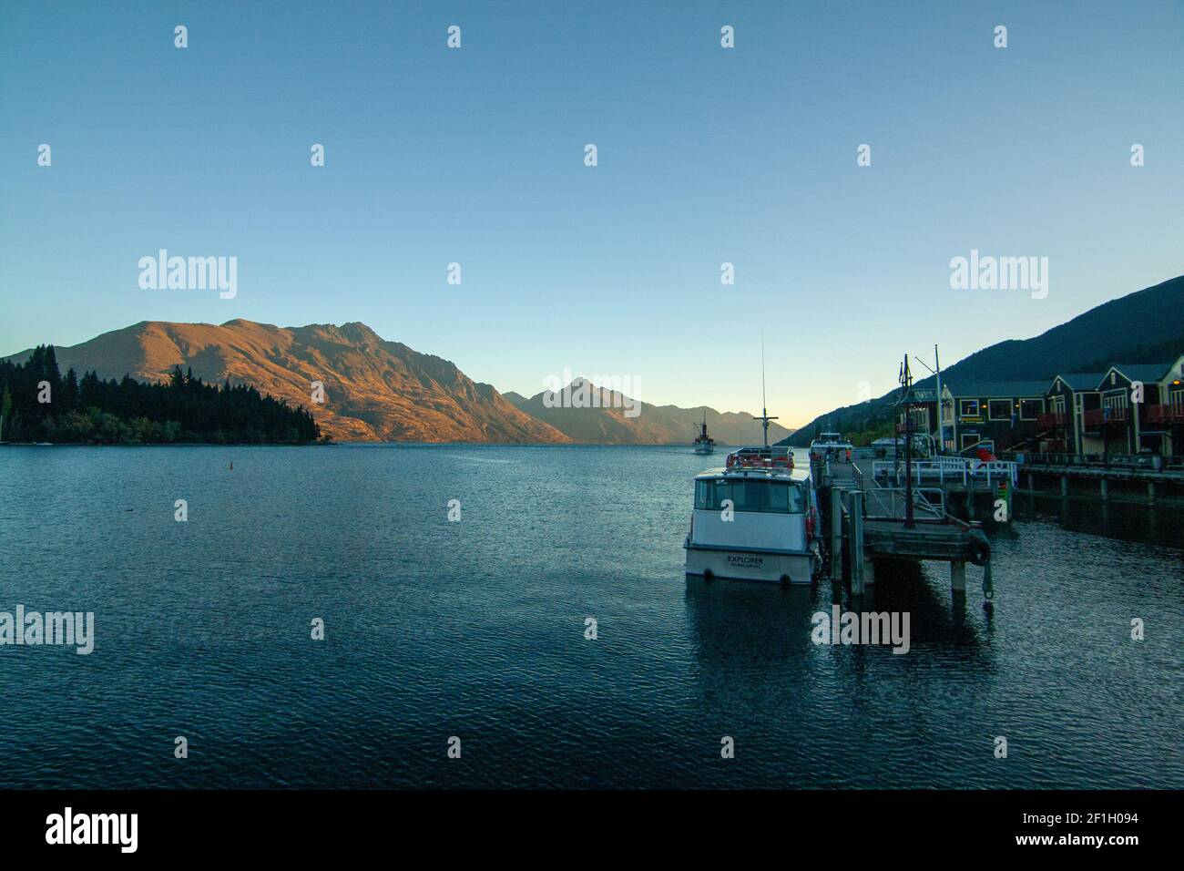 Queenstown Wharf and Harbour View of Lake Wakatipu and Mountain Peaks at Sunset Lights on background, New Zealand, South Island Banque D'Images