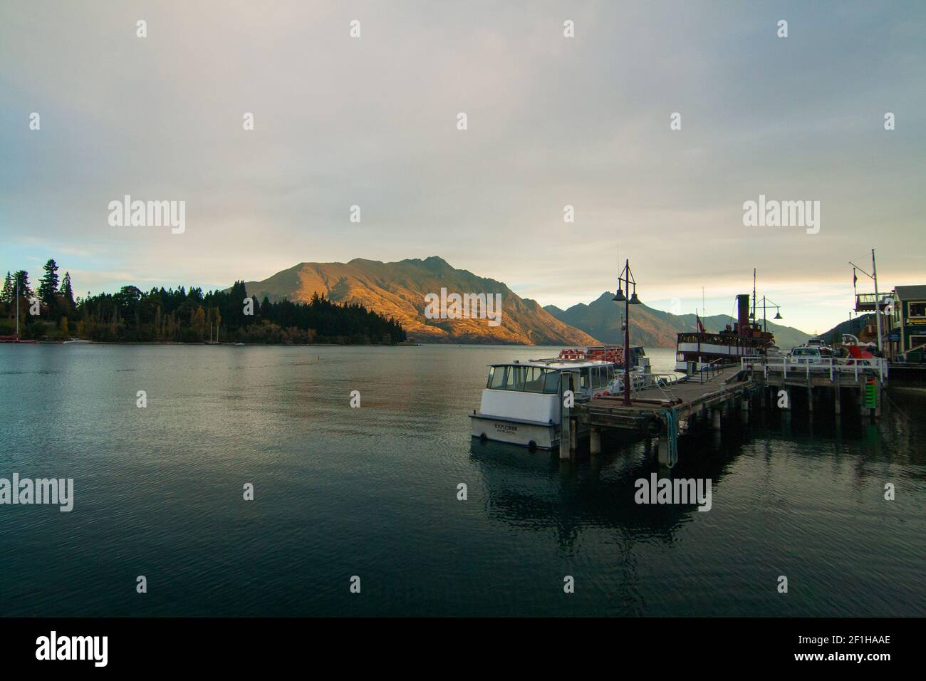 Queenstown Wharf and Harbour View of Lake Wakatipu and Mountain Peaks at Sunset Lights on the background, New Zealand, South Island Banque D'Images
