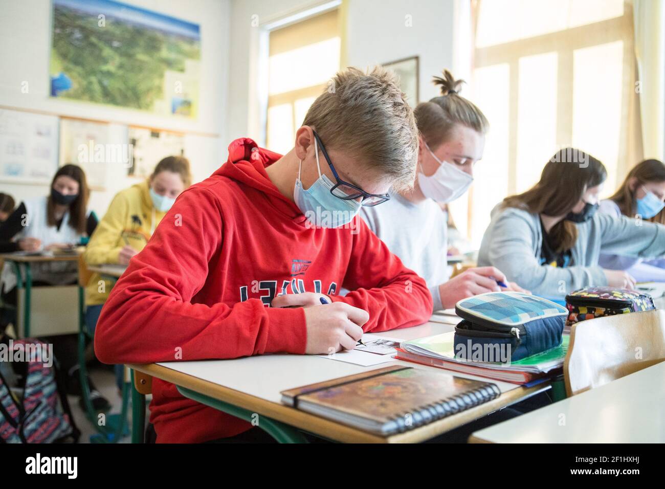 Jesenice, Slovénie. 15 février 2021. Les élèves du secondaire portant un masque facial assistent à une conférence dans une salle de classe de l'école secondaire Jesenice.les élèves des trois premières années d'école secondaire se sont joints à leurs pairs de quatrième année lorsqu'ils retournent à l'école après un confinement dû à la pandémie COVID-19. Crédit : SOPA Images Limited/Alamy Live News Banque D'Images