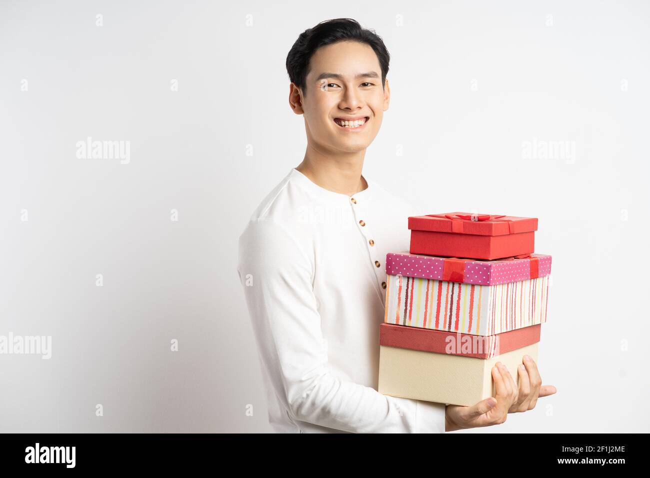 L'homme d'affaires asiatique tenait trois boîtes-cadeaux dans la main Banque D'Images