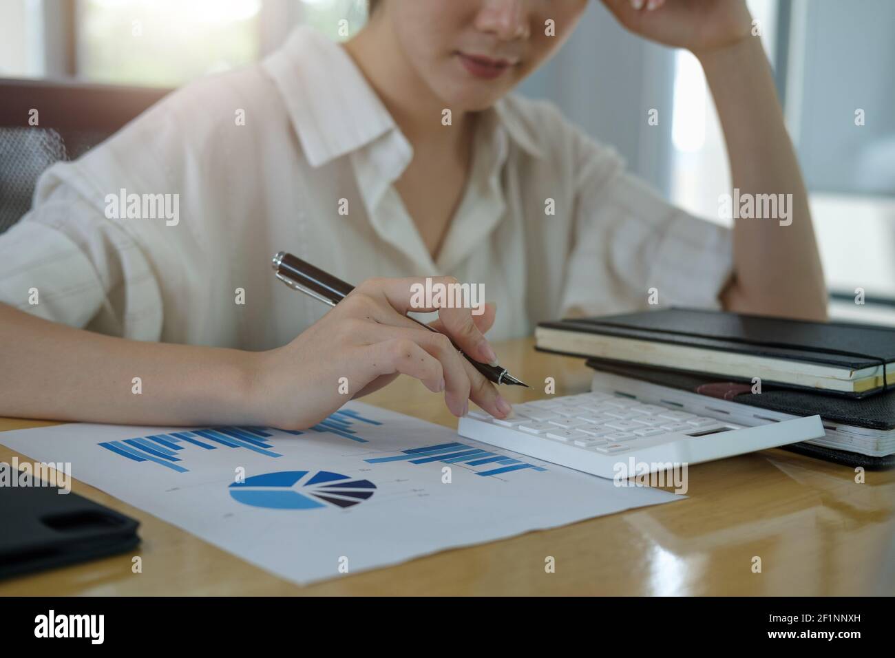 Gros plan mains de femme d'affaires ou comptable travaillant sur bureau avec l'utilisation d'une calculatrice pour calculer les chiffres, finance concept de comptabilité Banque D'Images