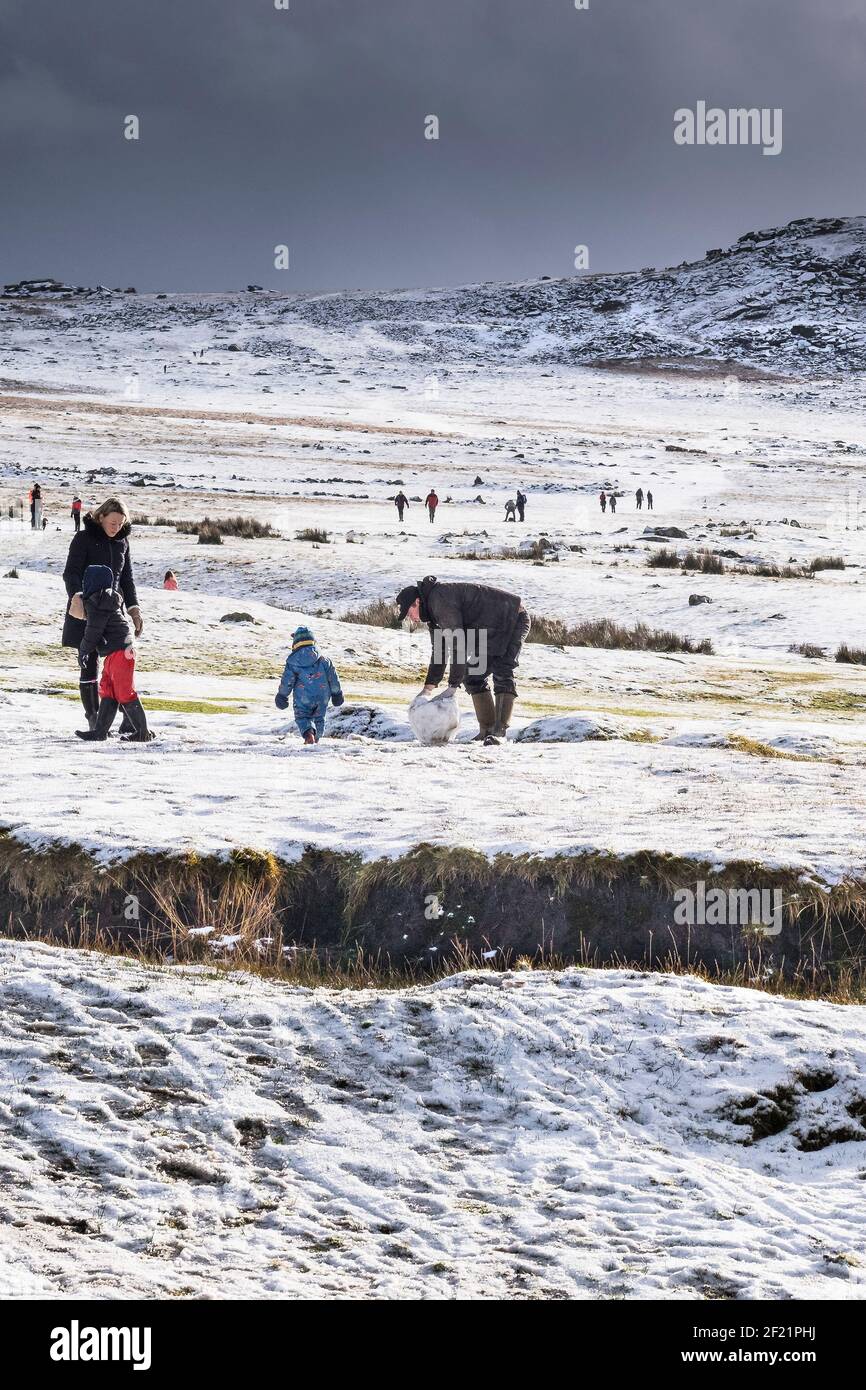 Les gens qui s'amusent dans la neige sur la sauvage robuste Tor Rough sur Bodmin Moor dans les Cornouailles. Banque D'Images