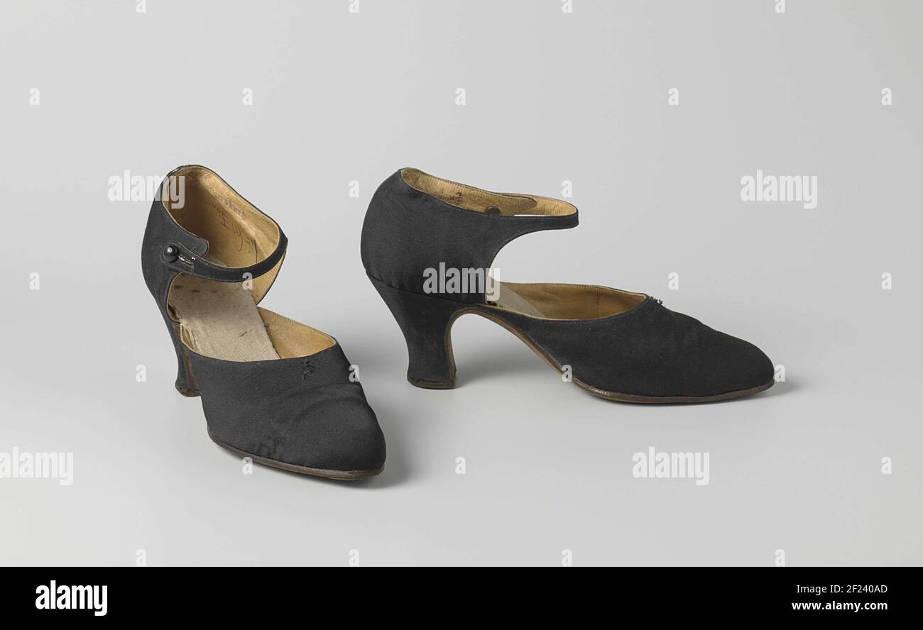 Chaussure pour femme en satin noir avec lanière de cheville. Modèle : bec  effilé arrondi, un détritus et deux lames latérales. La découpe de la page  de garde se trouve en haut