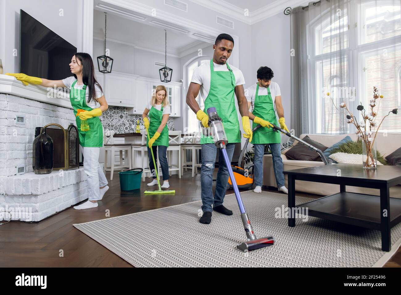 Équipe de divers professionnels de nettoyage de course mixte et dur de  service de nettoyage, travaillant ensemble dans la maison de luxe moderne,  à l'aide d'outils de nettoyage Photo Stock - Alamy