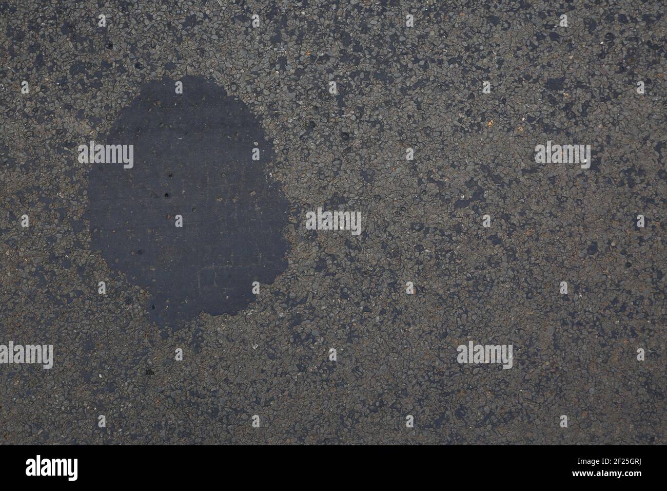 Asphalte gris avec fond de gros plan de point de bitume Banque D'Images