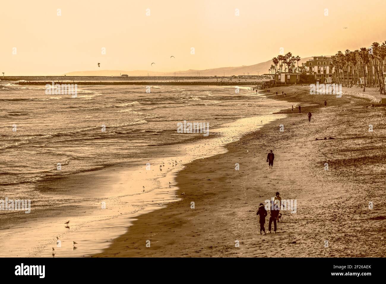 Touristes sur la plage avec des vagues ondulantes, des tons sépia. Banque D'Images