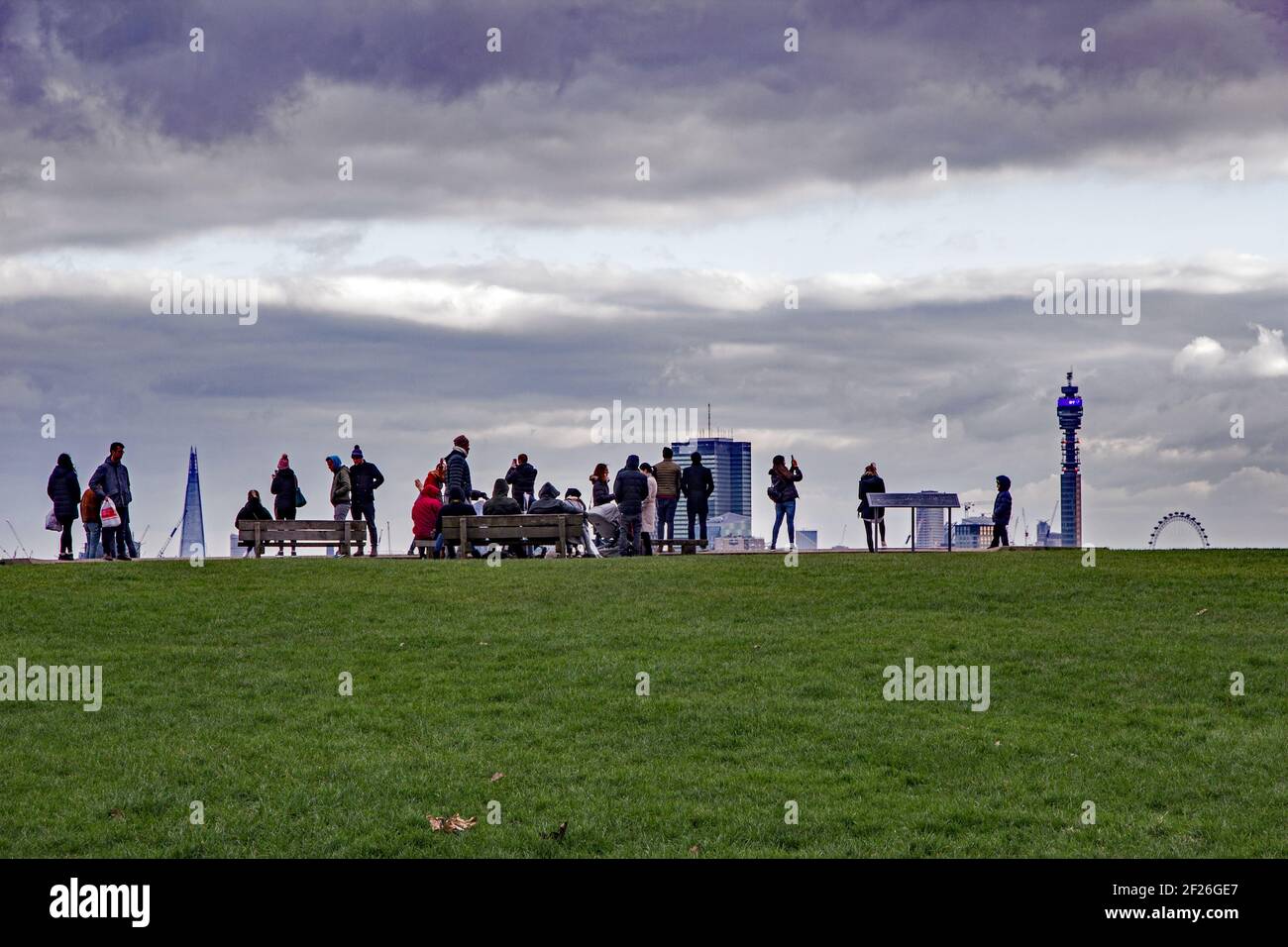 Point de vue unique des touristes posant et prenant des photos sur le front d'une colline avec les célèbres monuments de Londres comme le Eye, Shard, comme toile de fond Banque D'Images