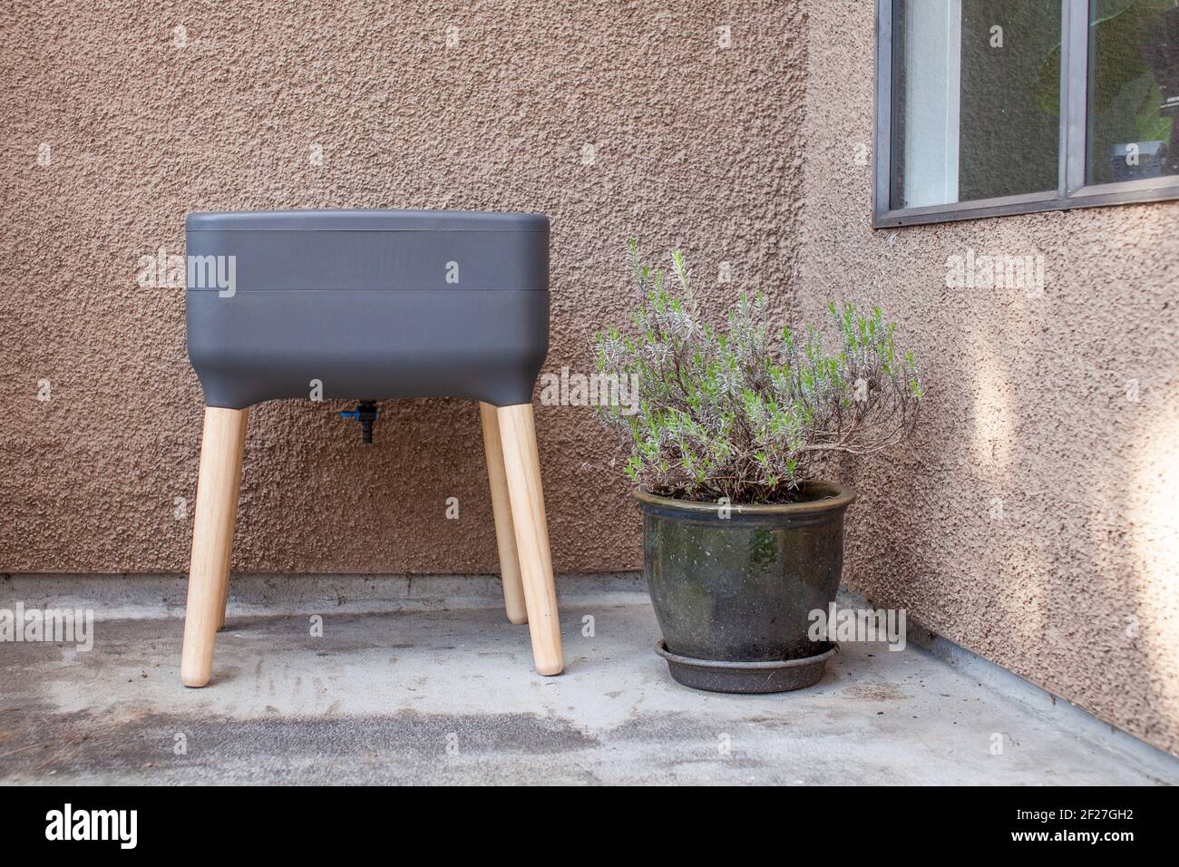 Un système de vermicomposter (worm composter) est installé sur un balcon d'appartement avec d'autres jardinières. Les vers mangent des restes de nourriture et produisent des moulages de vers et Banque D'Images