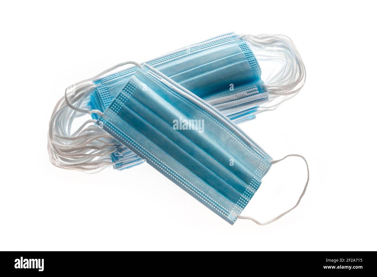Masques médicaux bleus, comme protection contre les virus, isolés sur fond blanc, concept covid19. Banque D'Images