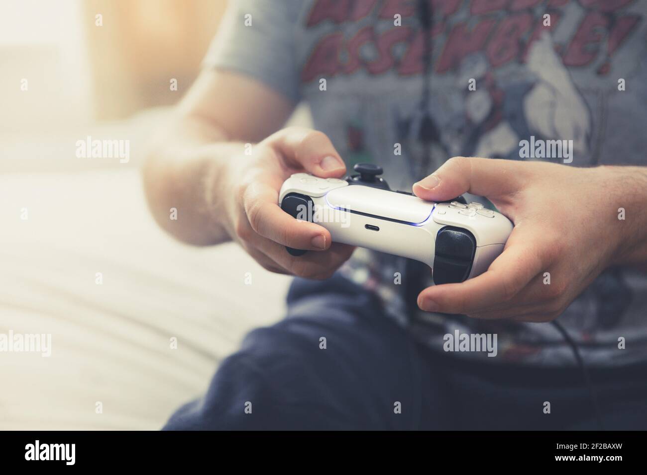 Gros plan sur un gamer masculin jouant à des jeux vidéo en ligne et à l'aide d'un combiné de contrôleur de console sans fil avec espace de copie Banque D'Images