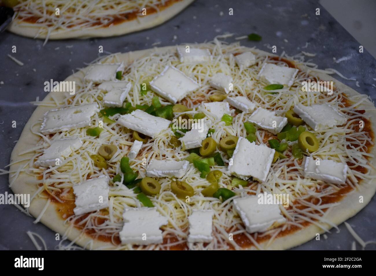 Préparation de délicieuses pizzas italiennes, concept de plats méditerranéens Banque D'Images