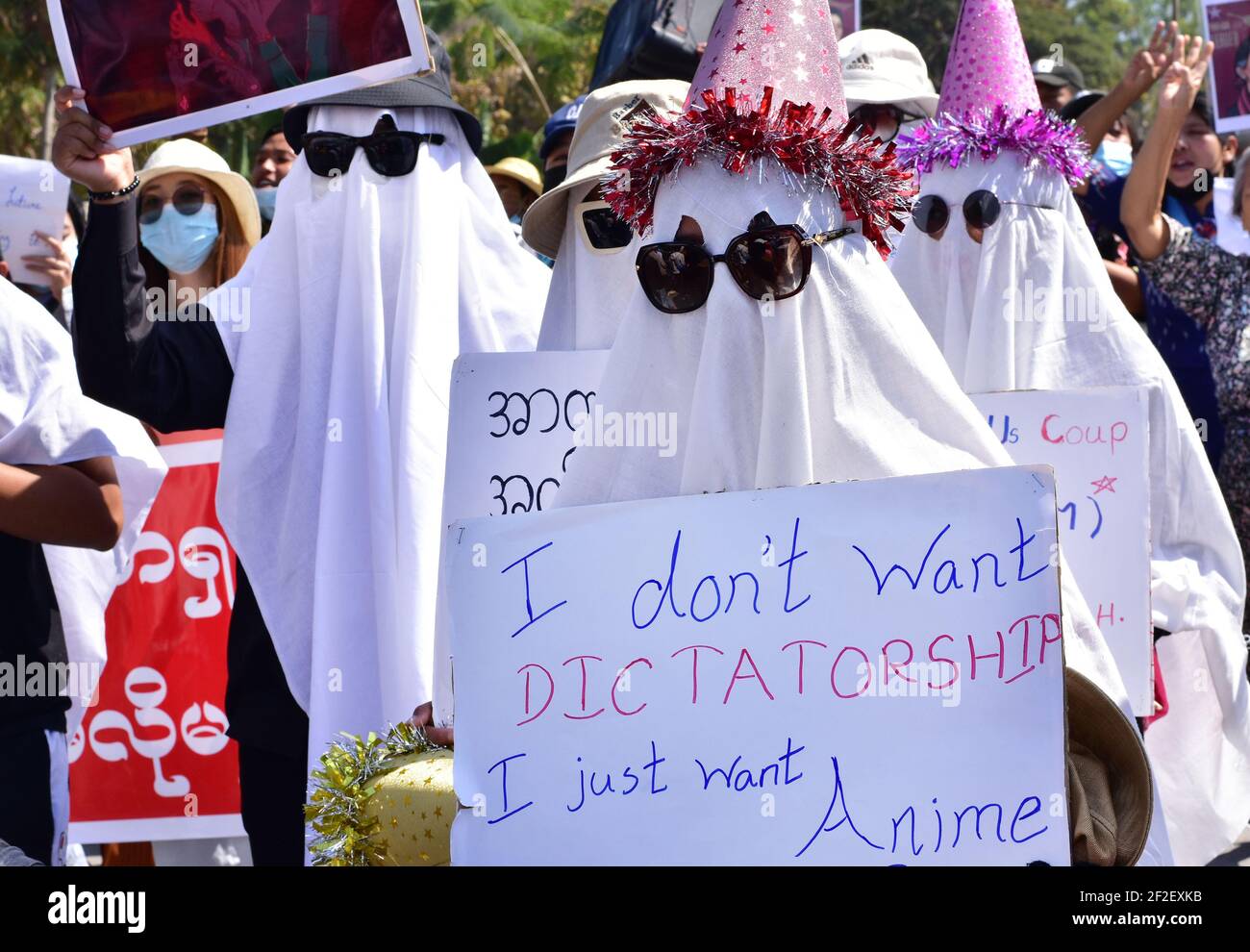 Myanmar. 12 février 2021. Les participants à une manifestation se rassemblent dans une rue portant des costumes fantômes et des panneaux indiquant « Je ne veux pas de dictature, je veux juste de l'anime ». Aussi choquante et froide que fut le coup d'État militaire au Myanmar début février, les manifestations qui ont débordé le pays peu de temps après ont été à l'origine colorées, créatives et imaginatives. (À dpa: 'De la robe de balle au bain de sang - la nouvelle génération du Myanmar défie la junta') Credit: Robert Bociaga/dpa/Alamy Live News Banque D'Images