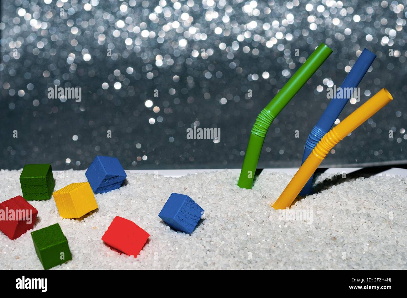 Plage de sable blanc avec pailles à boire et bois coloré cubes Banque D'Images