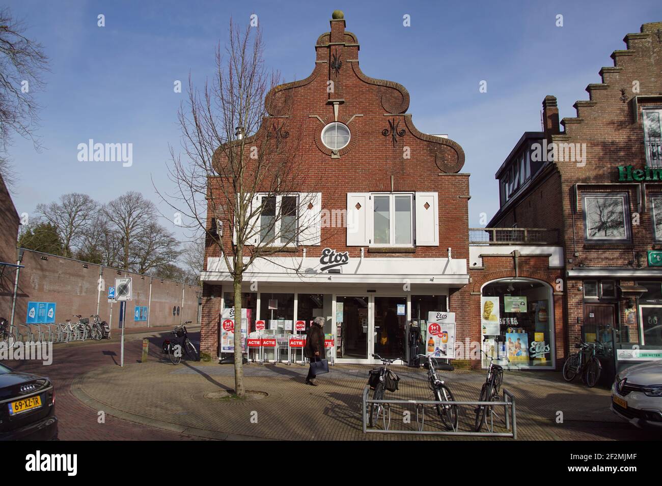 Pharmacie Etos dans une maison avec pignon cloche et une fenêtre de magasin. Rue commerçante dans le village néerlandais de Bergen. Vélos devant la boutique. Banque D'Images