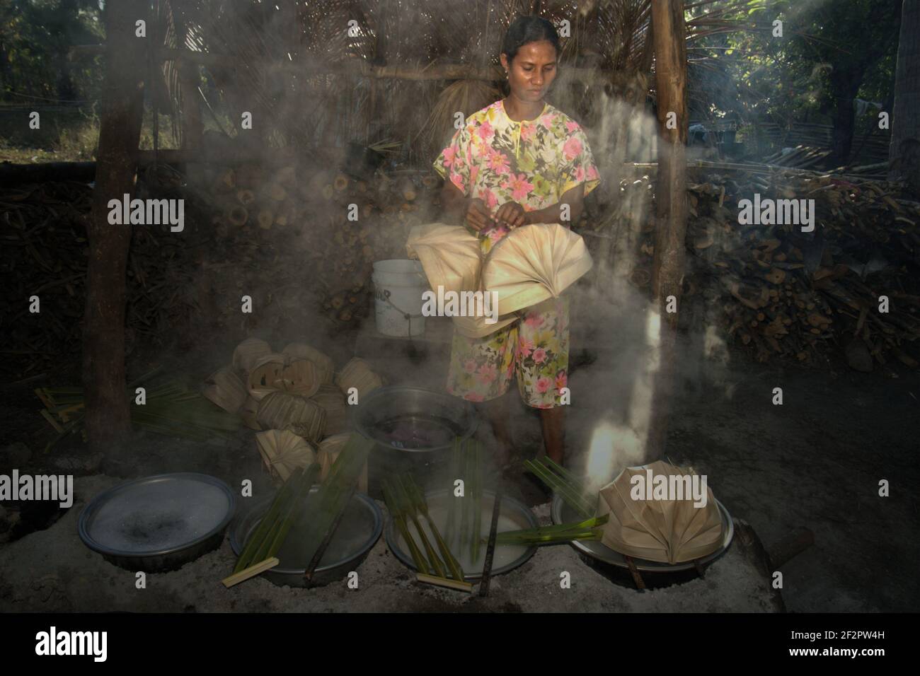 Yunce Unbanu faire bouillir la sève de palmier à l'aide de bois de feu dans le village d'Oehandi, île de Rote, Indonésie. Banque D'Images