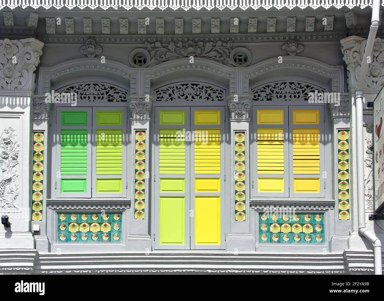 Boutique traditionnelle colorée de Singapour avec bois antique vert jaune Volets dans l'historique Geylang Banque D'Images
