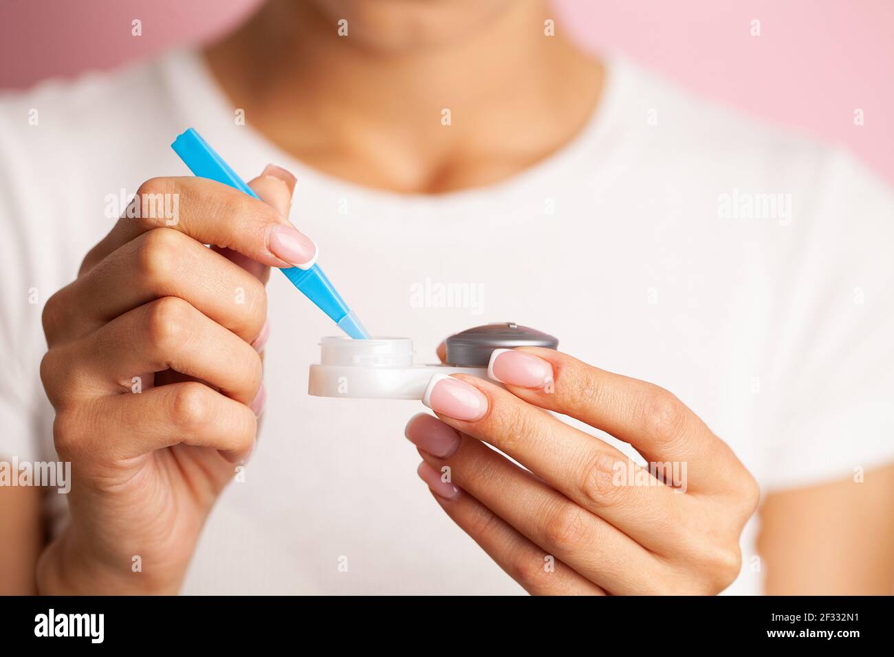 Jeune femme mettant la lentille de contact des yeux sur ses yeux Banque D'Images
