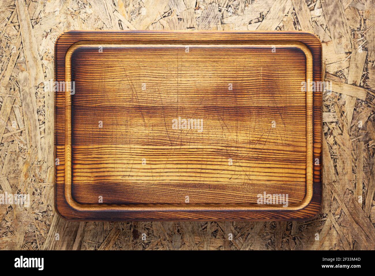 Planche pour la découpe de viande ou de pain sur table sur bois arrière-plan Banque D'Images