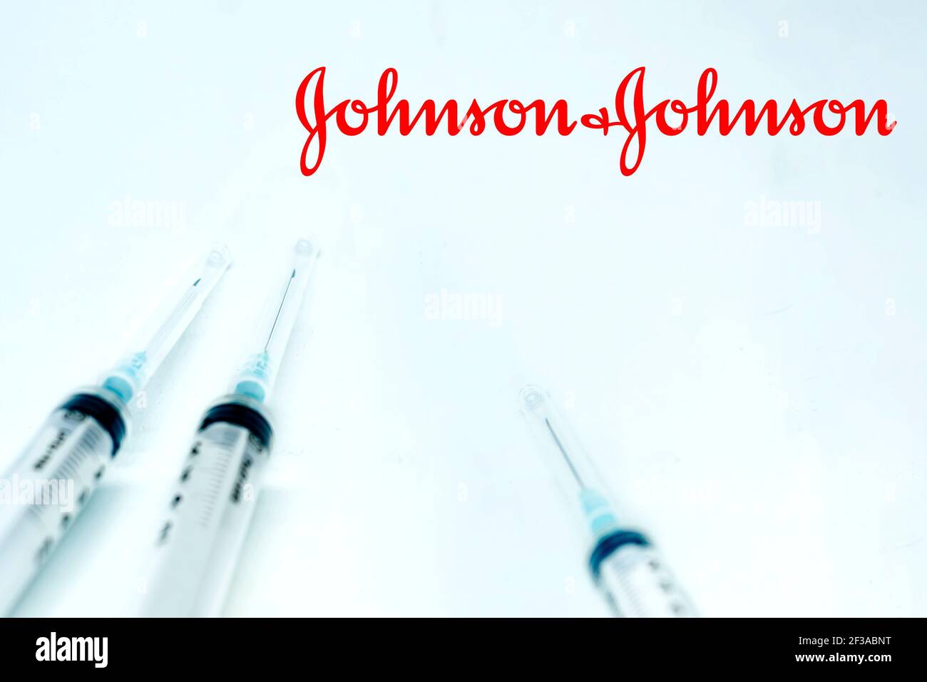 New Brunswick, NJ, USA, 10 février 2021 : trois seringues à côté du logo Johnson & johnson isolées sur fond blanc. Santé et prévention. J Banque D'Images