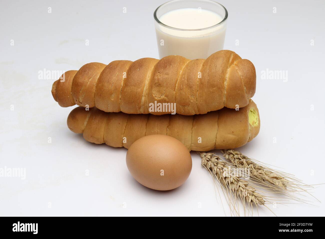 le rouleau de crème et le blé mûr et l'oeuf et le lait arrière-plan blanc Banque D'Images