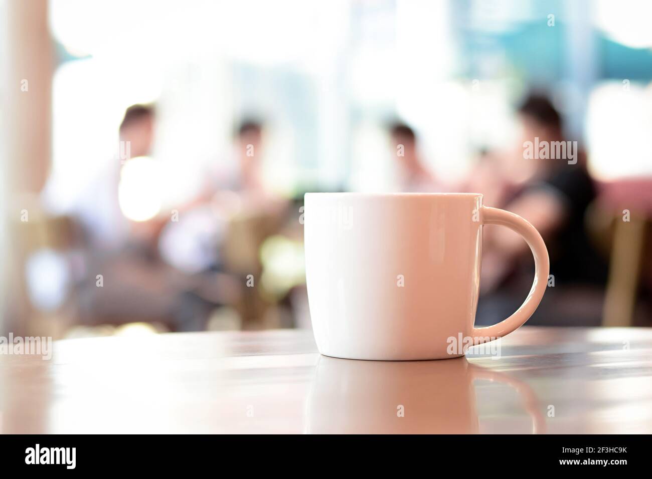 Une tasse de café sur la table avec des personnes dans le café-restaurant comme arrière-plan flou Banque D'Images
