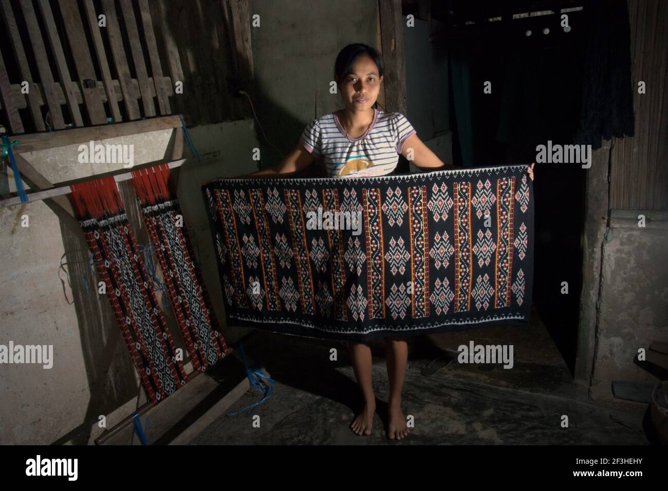 Koten montrant un tissu tissé traditionnel de l'île de Rote que sa famille a créé dans le village de Ndao, l'île de Rote, la régence de Rote Ndao, province de l'est de Nusa Tenggara, Indonésie. Chaque mois, la famille produit trois tissus dont le prix est compris entre 300,000 et 500,000 IDR. Banque D'Images