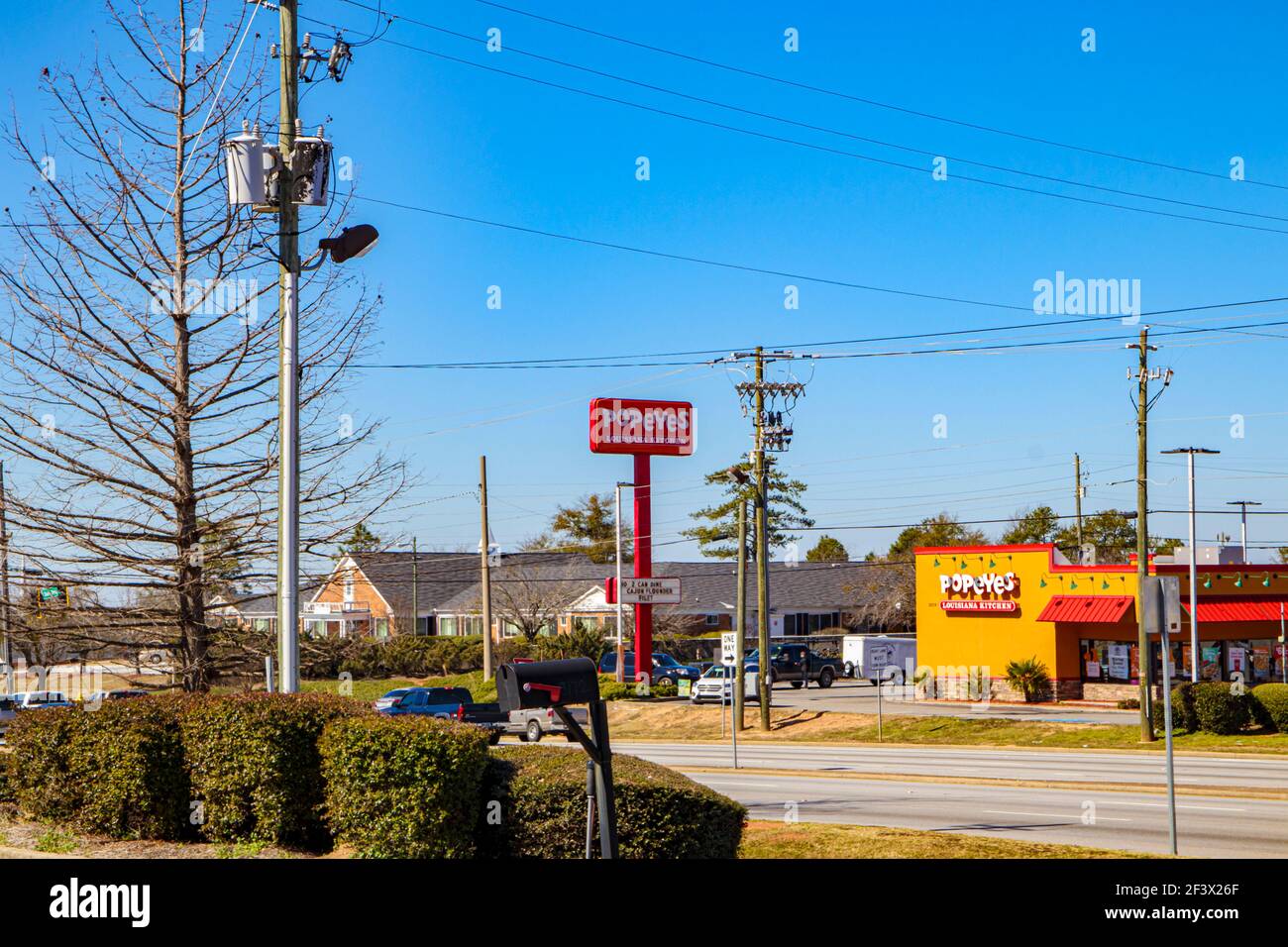 Augusta, GA USA - 02 21 21: Vue à distance de la circulation et Popeyes frit poulet restaurant bleu clair jour Banque D'Images