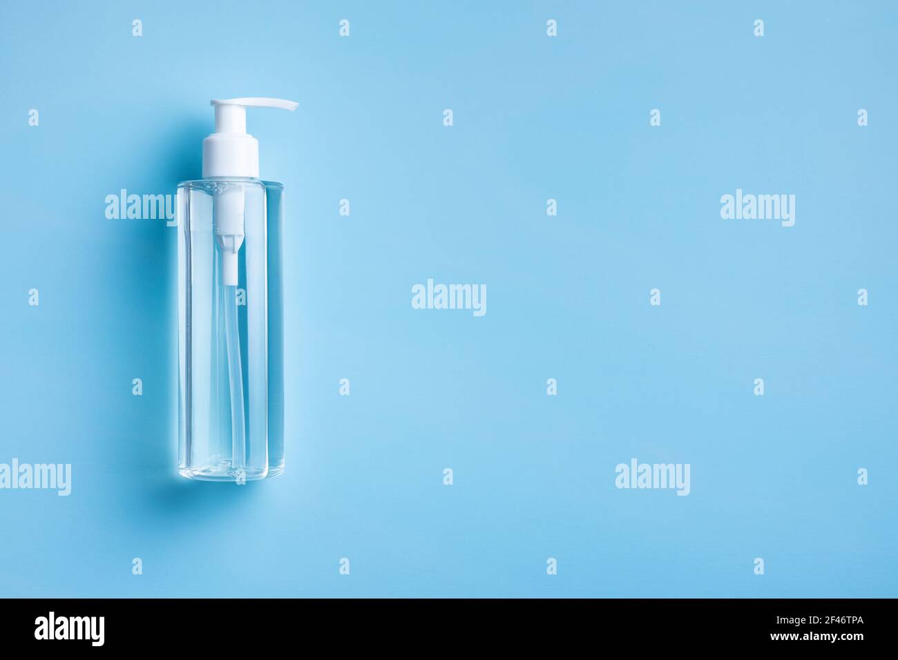 Gel désinfectant pour les mains anti-coronavirus en flacon. Gel désinfectant pour les mains sur une table bleue. Vue de dessus. Banque D'Images