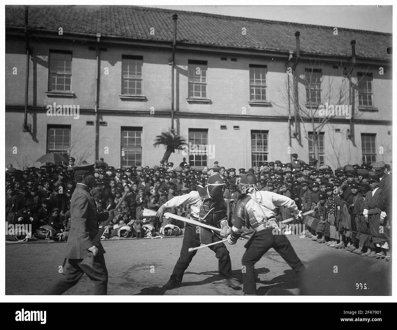 Nagasaki. Deux soldats japonais en escrime devant les spectateurs. Vue contre une caserne Banque D'Images