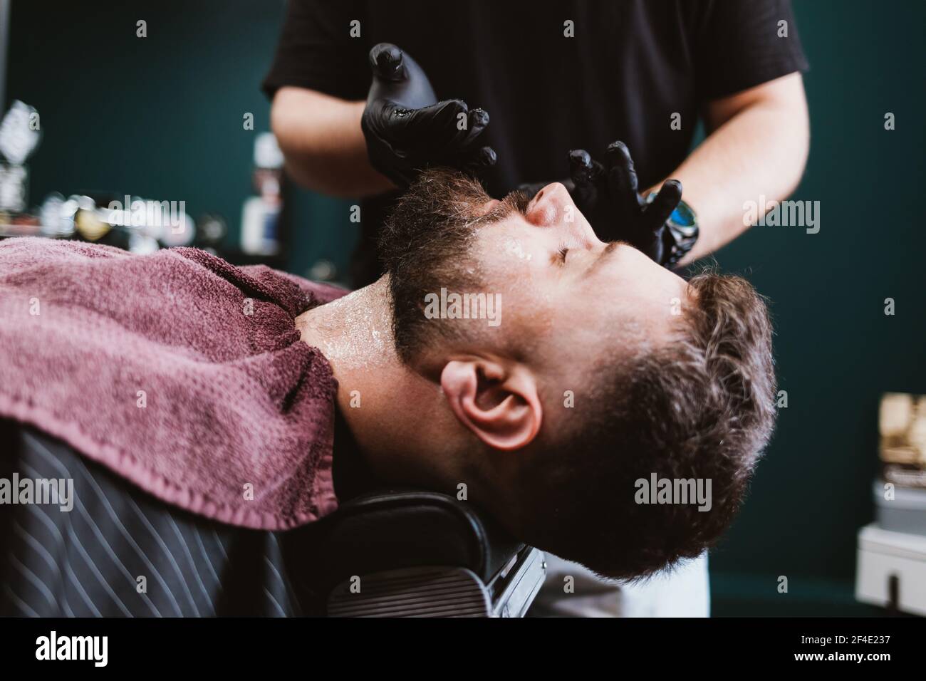 Rasage et soin de la barbe dans le salon de coiffure, l'application de gel  cosmétique sur le cou et le visage du client masculin pour faire des hommes  procédure de beauté Photo