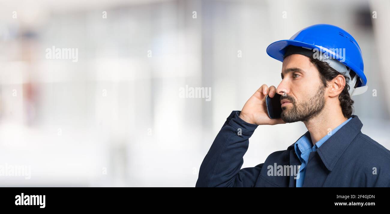 Portrait d'un beau ingénieur utilisant un téléphone portable Banque D'Images