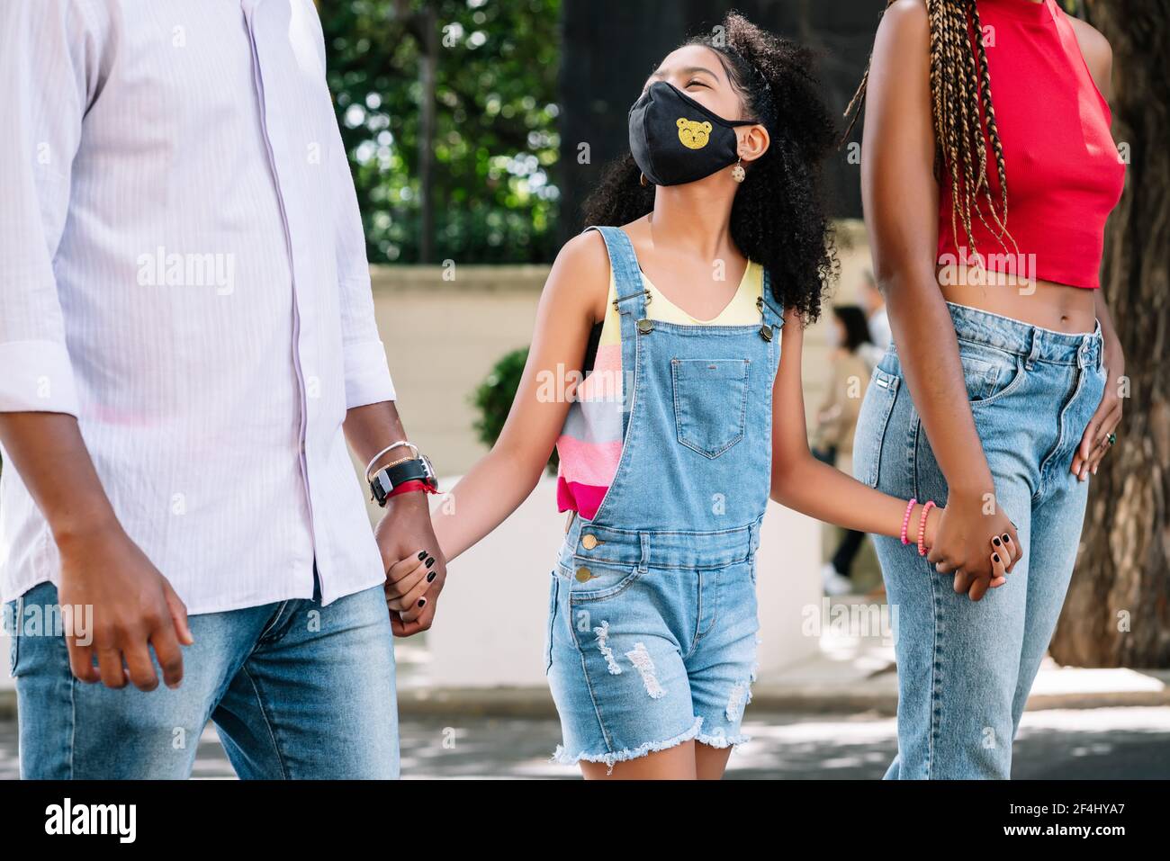 Petite fille appréciant une promenade à l'extérieur avec ses parents. Banque D'Images
