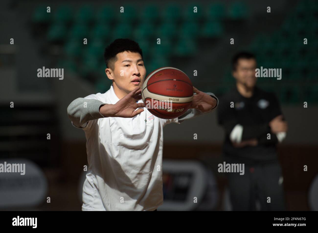 Baoji, province chinoise de Shaanxi. 22 mars 2021. Un stagiaire passe le bal lors du cours de mini-niveau d'entraînement à Baoji, dans la province de Shaanxi, dans le nord de la Chine, le 22 mars 2021. Au total, 53 entraîneurs de base sélectionnés ont suivi le cours de mini-niveau organisé par la FIBA BG Basketball Academy pour apprendre les connaissances générales de basket-ball et les compétences de base en coaching pour les programmes pour enfants, la nutrition, la prévention des blessures et les tactiques. Credit: Wei Xiang/Xinhua/Alay Live News Banque D'Images