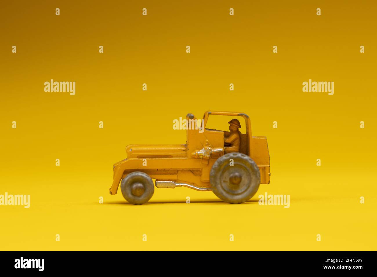 Le jouet de studio reste vivant sur un fond jaune sans couture. Banque D'Images