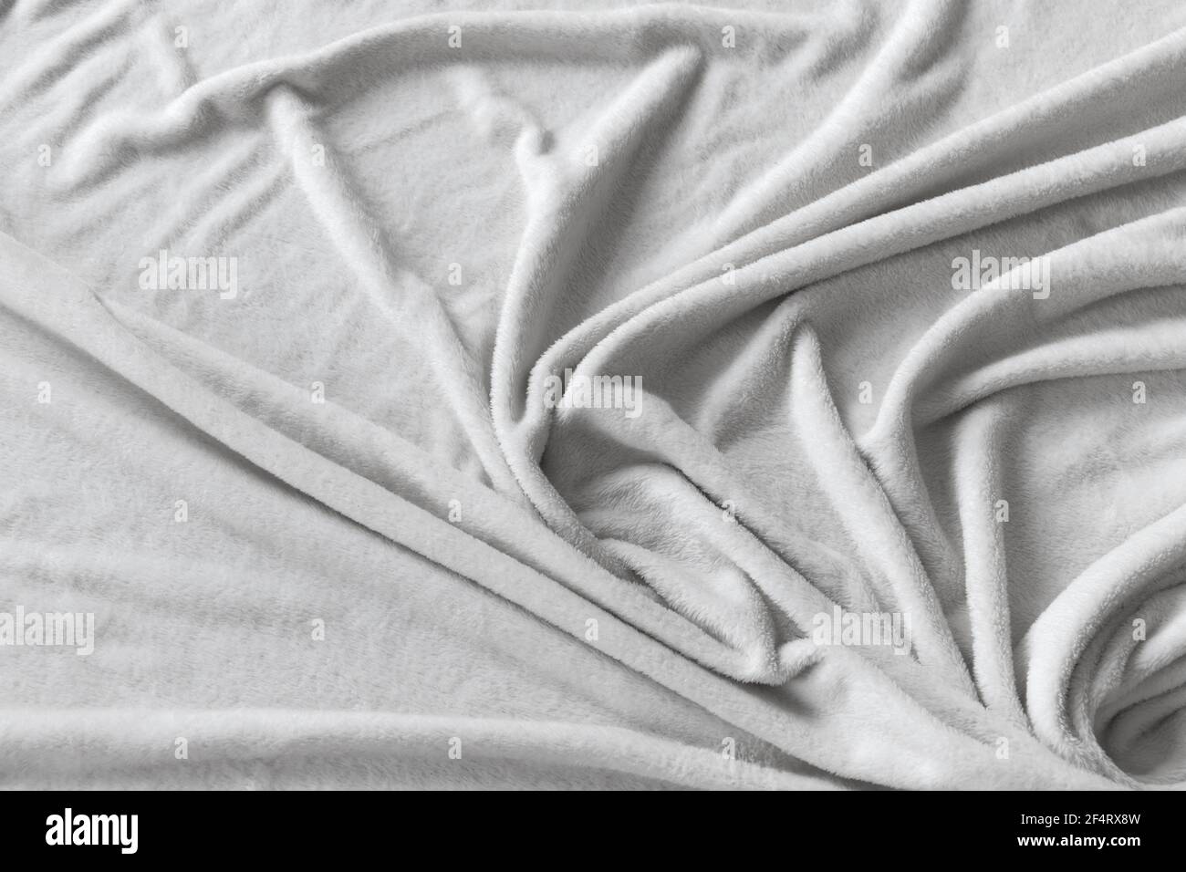 Couverture blanche moelleuse. Texture d'arrière-plan de tissu isolant blanc à recouvrement doux en polyester Banque D'Images